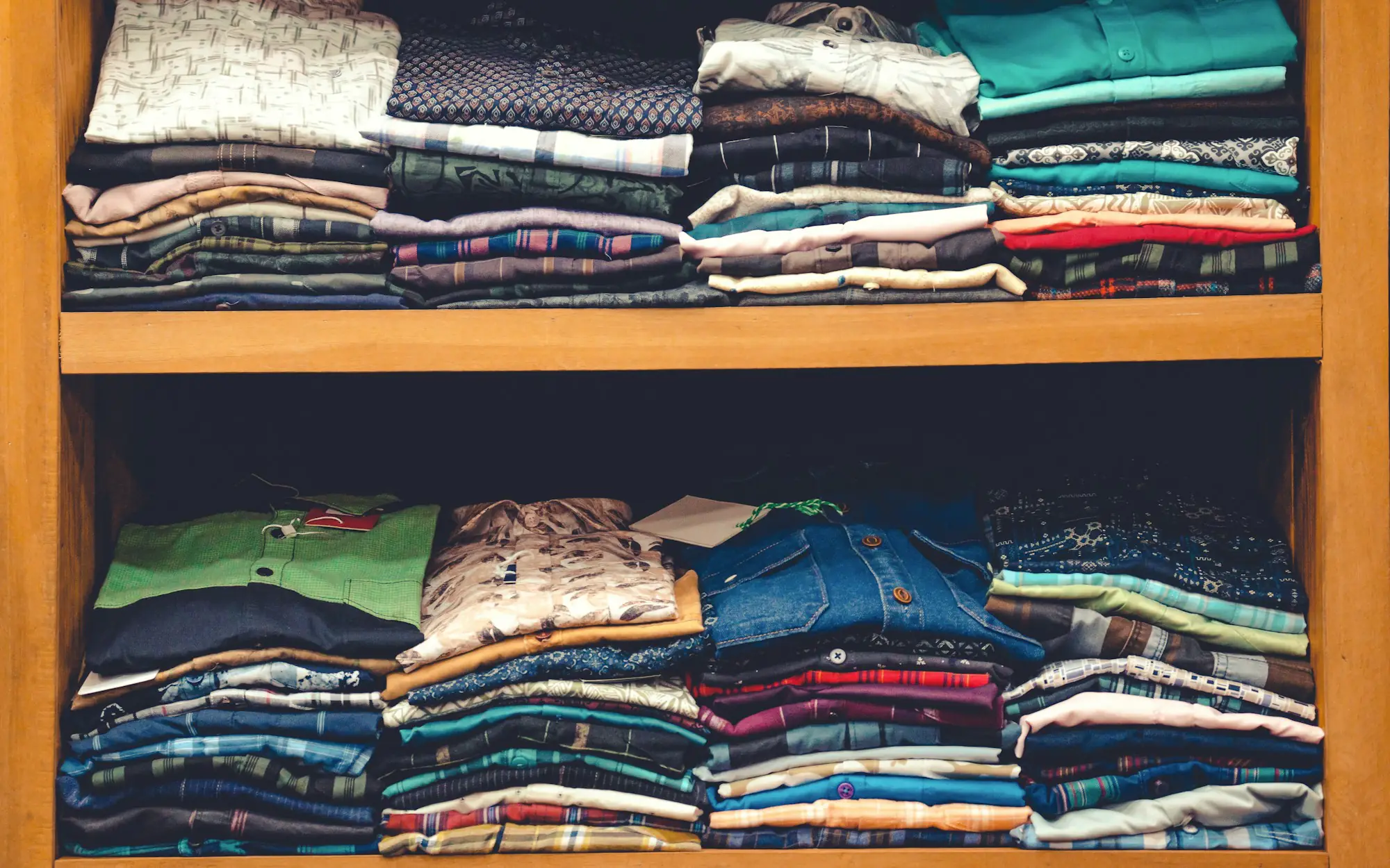 Shelves stacked with folded shirts
