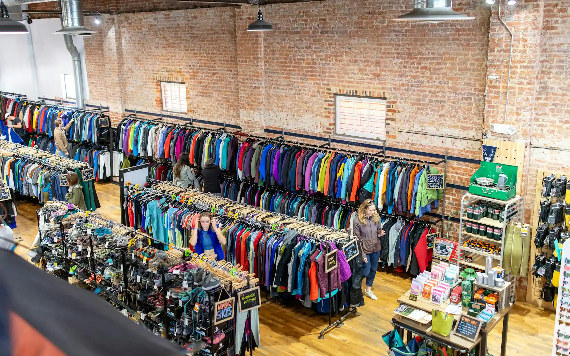 A thrift store with racks of colorful clothes